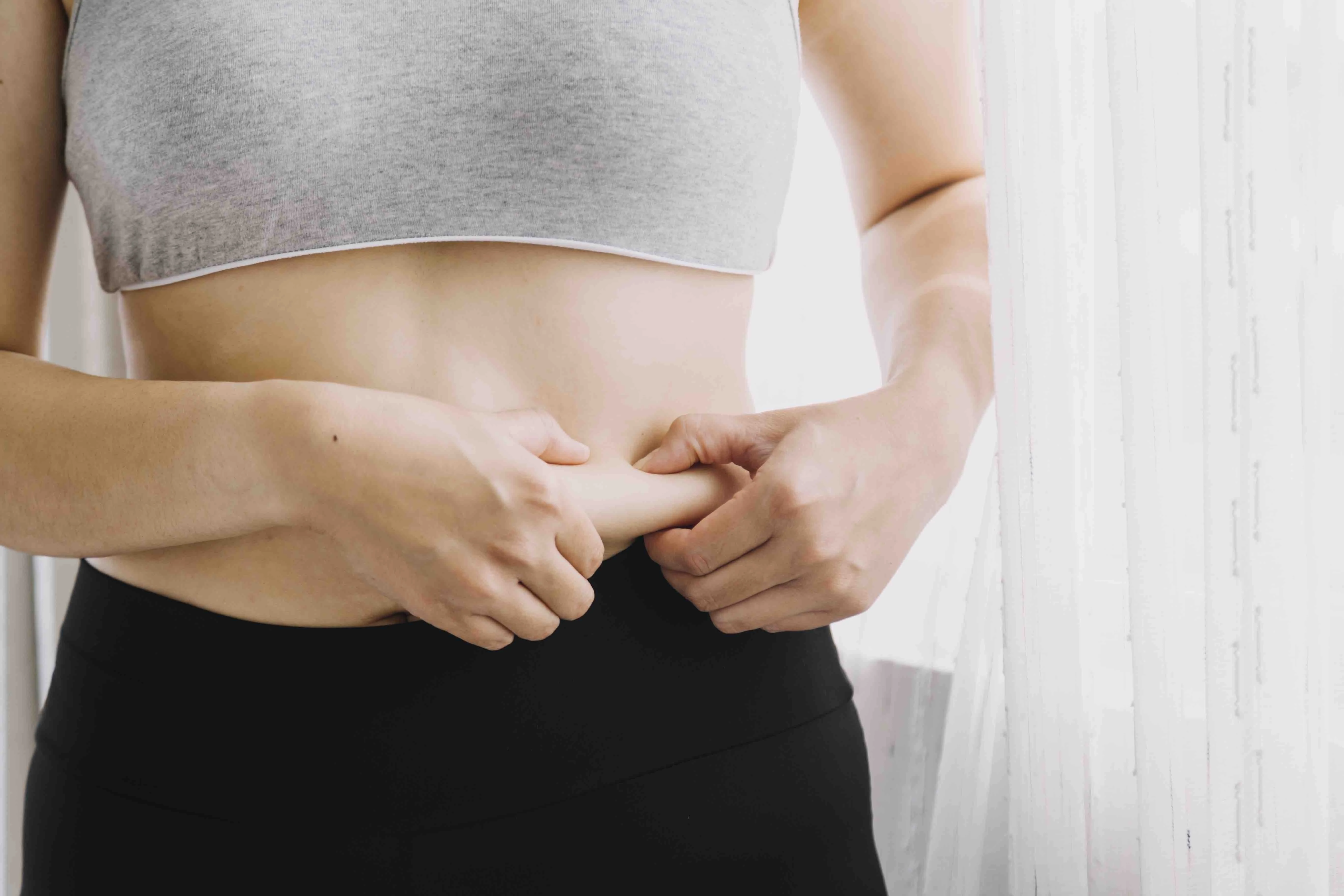 Beautiful Fat Woman With Tape Measure She Uses Her Hand Squeeze Excess Fat That Is Isolated White Background She Wants Lose Weight Concept Surgery Break Down Fat